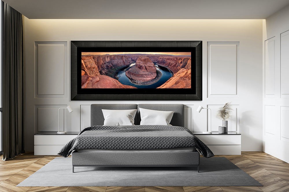 Large framed print of horseshoe bend hanging in master bedroom