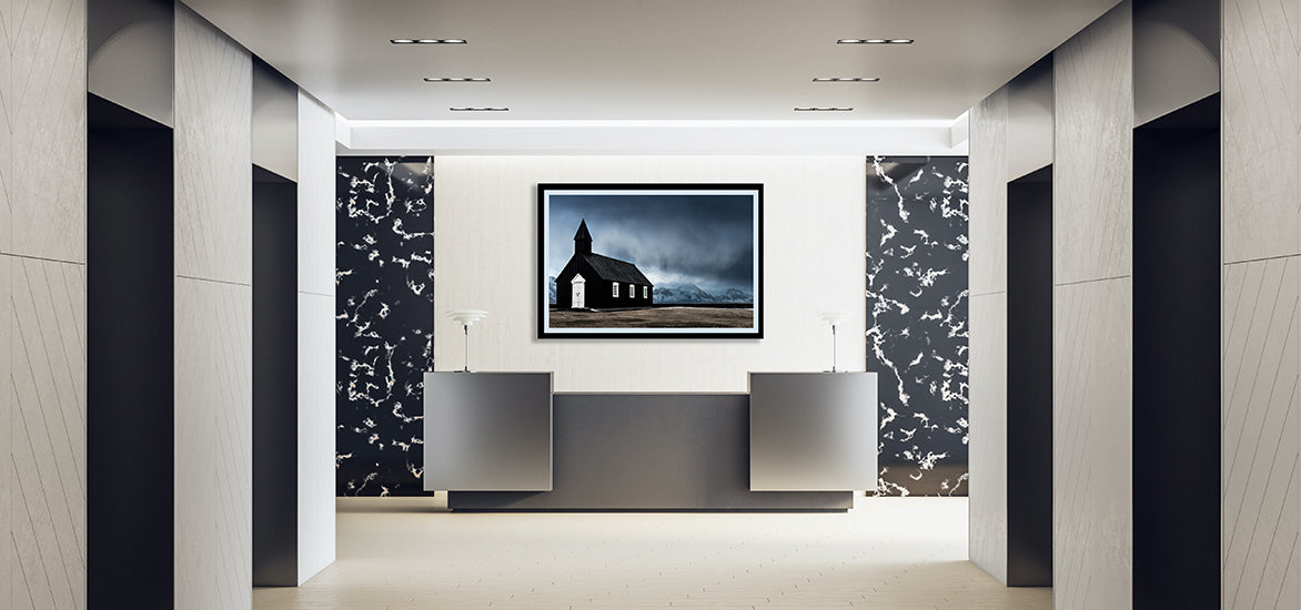 framed print of black Icelandic church and mountain range