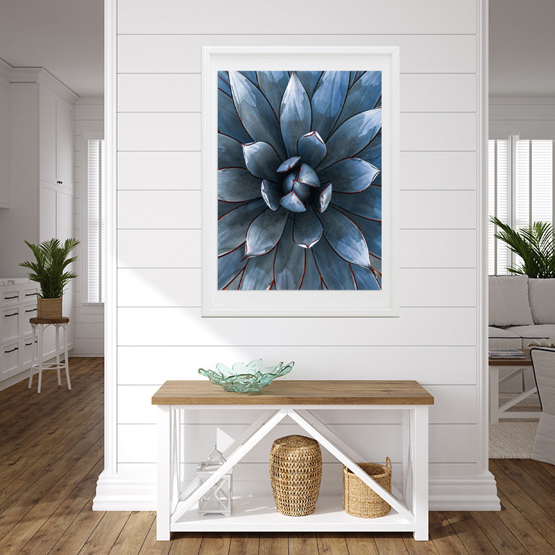 framed print of a blue cacti hanging on a wall