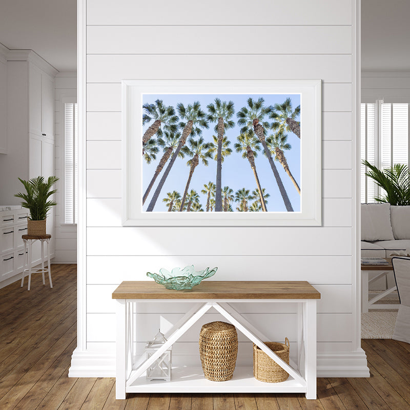 Frame print of tall palm trees against a blue sky