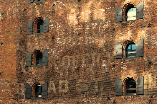 A very interesting brick wall in brooklyn with small shuttered windows